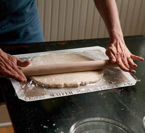Starting at the short end, roll up the dough to form a log.