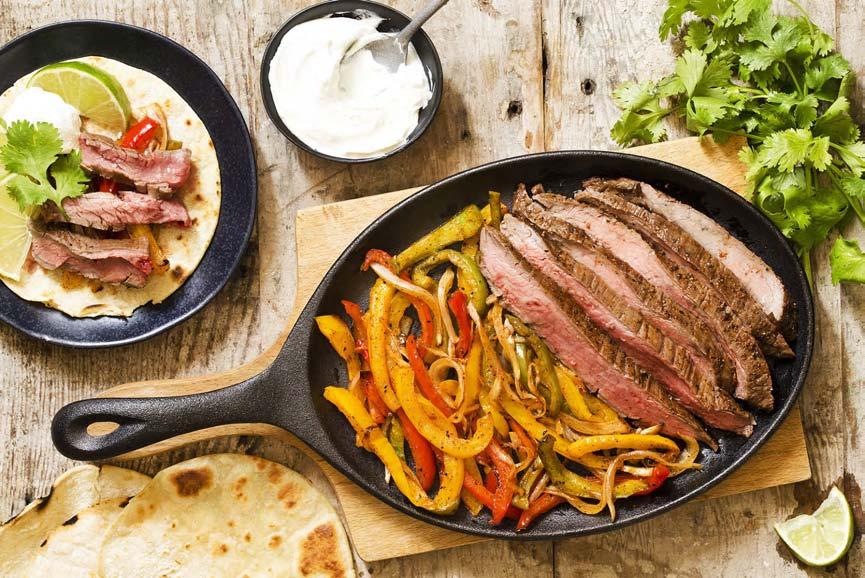 MAIN ENTREES Grilled Beef Fajitas 1/2 pound flank or skirt steak 1/4 cup vegetable oil 1/4 cup soy sauce 1/4 cup lime juice 1 garlic clove, minced 2 tablespoons brown sugar 2 teaspoons chili powder 1