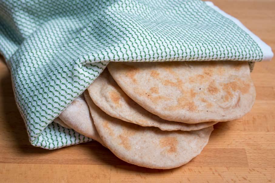 YIELD 8 PITAS PREP TIME 10 MINUTES COOKING TIME 3-4 MINUTES EACH 1 TABLESPOONS DRY ACTIVE YEAST 1 TEASPOON SUGAR 1 CUP WATER 6 OZ. WHOLE WHEAT FLOUR 6 OZ.