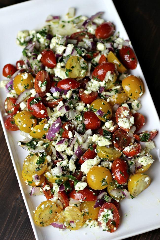 Salt 1/2 teaspoons Black Pepper 1 cup Feta Cheese, crumbled Cut your tomatoes in half and add to a mixing bowl Add chopped red onions, olive oil,