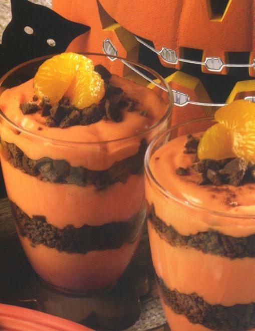 Halloween parfait 3 boxes instant vanilla pudding 1 teaspoon red food coloring 1/2 teaspoon yellow food coloring one 9-ounce package plain chocolate wafers 6 cups milk chocolate syrup to taste one
