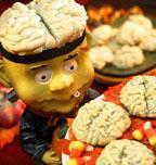 MOUNDS OF BRAINS cookies 1 cup butter (softened) 4 cups all-purpose flour 2 cups white sugar 3 eggs 1 tube black food coloring 1 colander Preheat oven to 350 degrees.