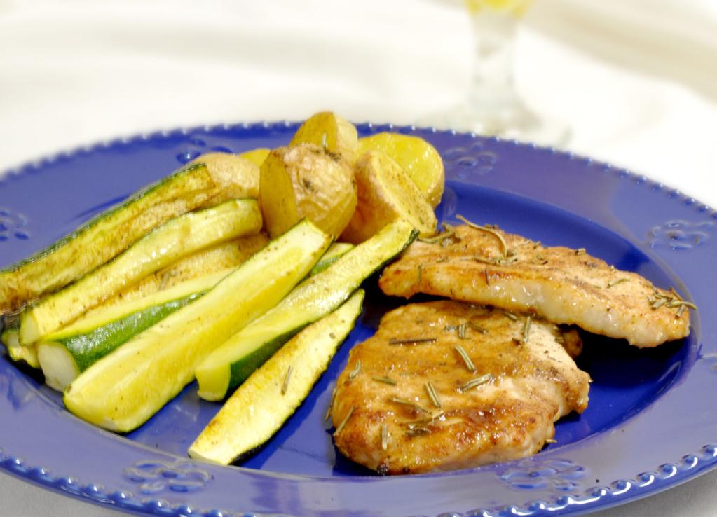 PORK MAKES 2 SERVINGS 2 boneless pork chops, approximately 12 oz 1/2 lb zucchini strips, approximately 1/2 x 1/2 x 2-1/2 inches 1-1/3 cups new potatoes, cut into 1/2-inch wedges 1 tsp olive oil 1.