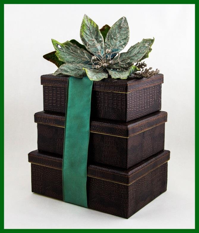 Holiday Magic Three handsome keepsake crocembossed gift boxes wrapped in a sophisticated ribbon and topped with a glittering poinsettia are