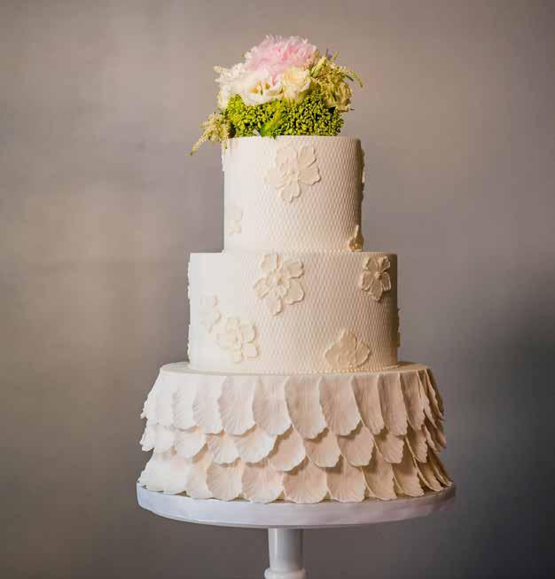 Petal Power A beautifully soft and delicate look incorporating ivory quilted fondant and hand made blush tone feathery petals, with fresh floral