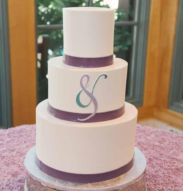 You & Me Silky smooth buttercream with fondant bands and embellishments, traditional elegance with a modern twist.