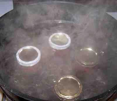 Step 13 - Process the jars in the boiling water bath Keep the jars covered with at least 1 inch of water. Keep the water boiling.