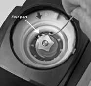 Cleaning the Grinding Chamber Exit Port: Turn the grinder so the back is facing you, then rotate the black adjustment ring counter clockwise until it stops.
