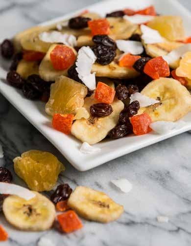 A colorful variety of raisins, banana chips, chipped coconut, pineapple and papaya bursting with