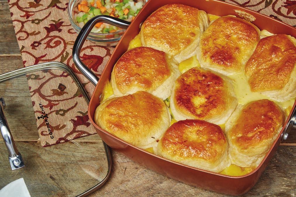 Skillet Chicken Pot Pie 1 26 oz. can cream of chicken soup 3 chicken breasts, diced 4 red potatoes, quartered 1 onion, peeled & diced 1 cup cream 3 carrots, peeled & sliced 1 tube of biscuits 1.