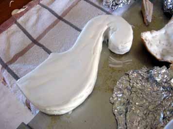 Painting the Pieces: I wanted my swan all white so I painted all the pieces with thinned-down Royal icing with the wide paint brush (just add water, a tablespoon at a time, to the icing so it s at a