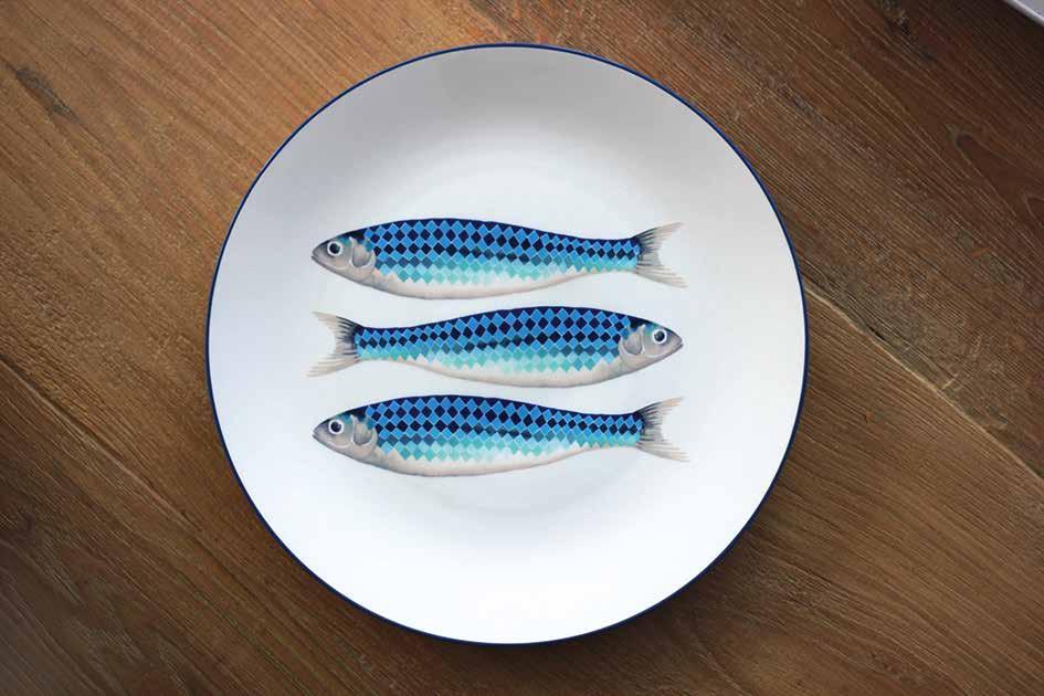 The fish plates, platters, pottery mugs and ceramic jugs are decorated with shimmering fish with rhombus-shaped scales in vibrant blue hues.