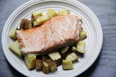 Lay on a parchment lined baking sheet and roast for 20 minutes. While potatoes are roasting, season the salmon fillet with salt and pepper and brush with the remaining olive oil.
