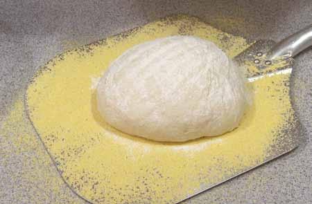 4 I chose to bake my bread on a pizza stone; therefore, I dusted a pizza peel with plenty of corn meal.