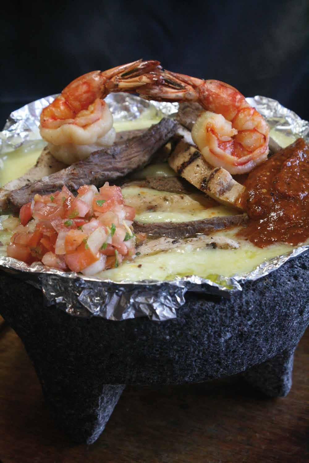 Molcajete OUR HOUSE SPECIALTY TACOS Here at Just Tacos Mexican Grill & Cantina each plate below comes with our specialty tortillas, spanish rice and refried beans for your