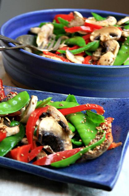 Snow Peas and Red Pepper Salad ¾ lb snow peas ½ lb mushrooms, sliced 1 small sweet red pepper, cut into strips 1 Tbsp sesame seeds Walnut orange dressing: 1 small clove of garlic, pressed ½ cup
