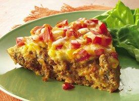 Taco Pie Serves 6 Equipment: 1 lb lean ground beef skillet whisk ½ cup finely minced onion strainer chef s knife 1 cup corn (canned or frozen) cutting board paring knife 1 cup grated cheddar non slip
