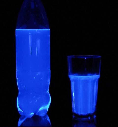 When the UV lamp is switched on, the tonic water fluoresces. This is because of the quinine in the tonic water.