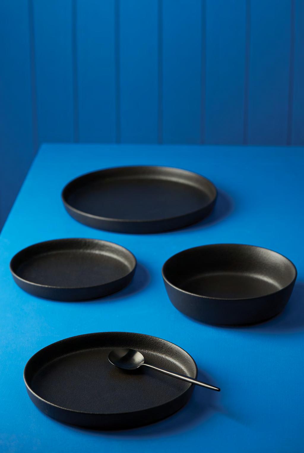 industry BUILT TO LAST Simple black clay dinnerware makes a bold statement and Industry is no exception.
