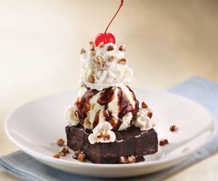 50 Chocolate brownie served warm and topped with vanilla ice cream,