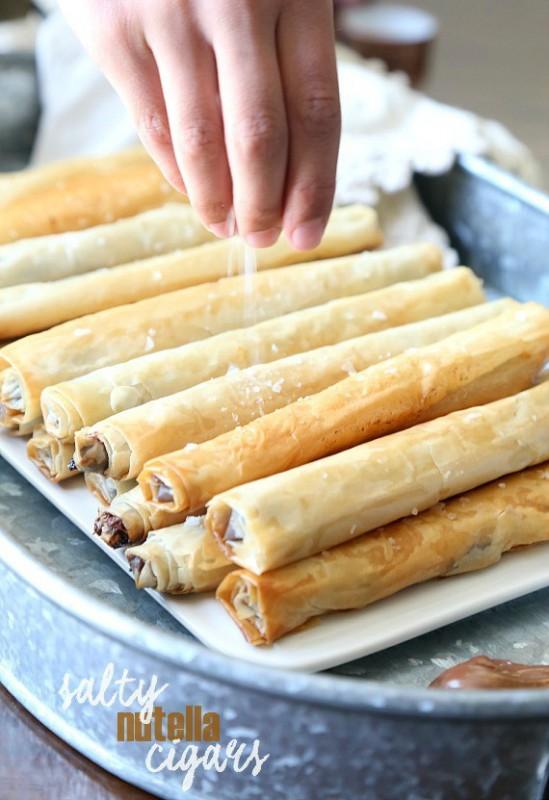 Salty Nutella Cigars Serves: 24 Ingredients 1½ cups Nutella spread 1 (8 ounce) package phyllo dough, thawed according to package directions ¾ cup butter, melted optional ~ flaked sea salt