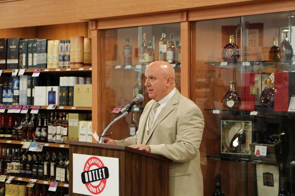 Photo caption 2: NHLC Chairman Joseph Mollica addresses a crowd at the June grand opening of New Hampshire s largest NH Liquor & Wine Outlet, located at the Rockingham Mall shopping plaza in Salem,