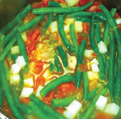 Green Beans with Tomatoes Ingredients: 1 1/2 pounds fresh green beans 1 large ripe tomato, cored and chopped 1/2 cup onion, chopped 1 clove garlic Directions: 1.