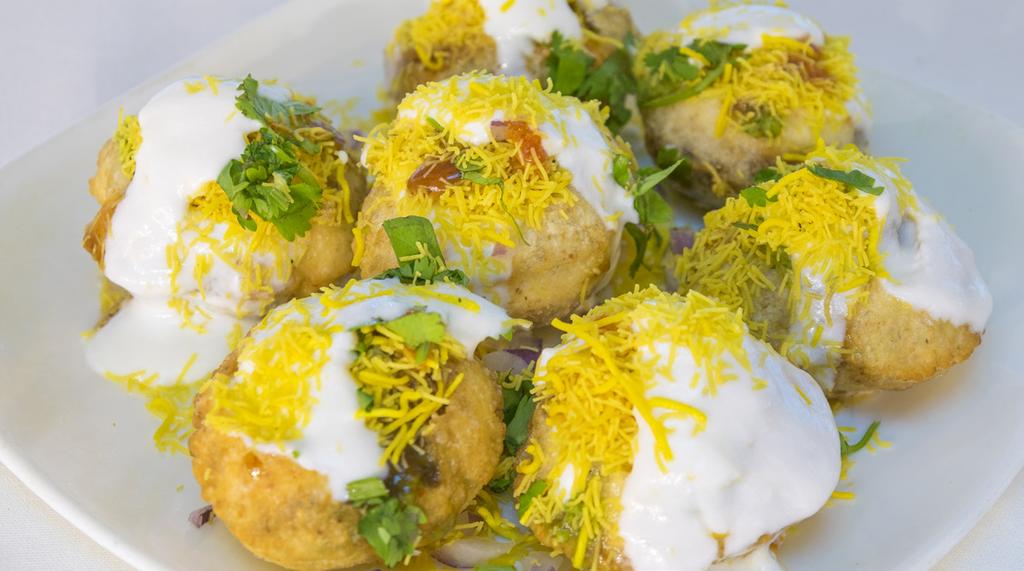 Paneer Chaat (Fresh cottage cheese mixed with onion, potatoes, coriander and yogurt sprinkled with noodles and cilantro) (Flour crisps with potatoes, chickpeas and onions topped with yogurt and sweet