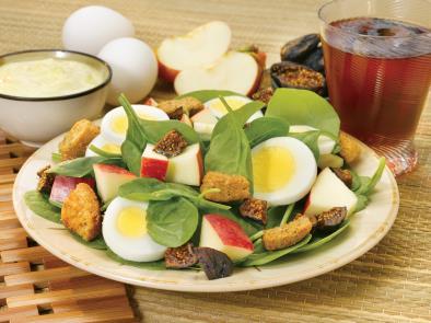 4 large eggs 2 apples 8 cups fresh spinach 1 cup dried figs (about 16 figs or one 7-oz pkg) 1 cup whole-grain croutons ½ cup light honey mustard or poppy seed dressing 1.