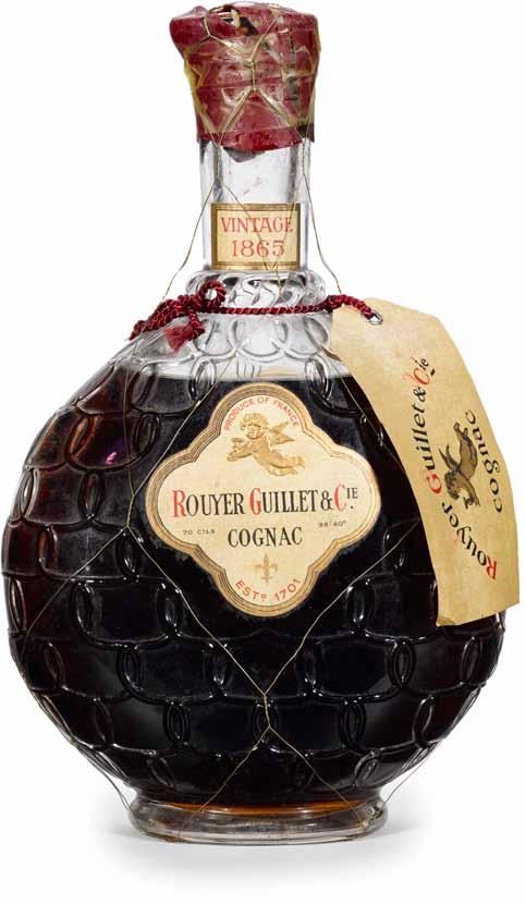 950 Rouyer Guillet Cognac 1865 (1) Rouyer Guillet & Cie. PC. Fancy, embossed glass decanter. Driven cork with accompanying glass and plastic stopper. Neck tag reads: Le Cognac des Rois de France.