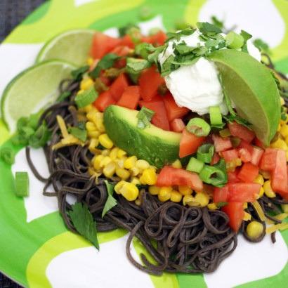 1-⅞ ounces, weight Dry Black Bean Spaghetti 4 cups Water 1 pinch Sea Salt ½ cups Canned Corn ½ Tablespoons Butter ½ whole Fresh Lime ¼ cups Fresh Cilantro 1 pinch Garlic Salt ½ ounces, weight Cheddar
