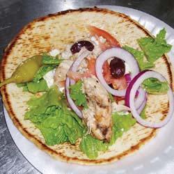 skinless, boneless chicken breast halves 4 large pita bread rounds 1 heart of romaine lettuce, cut into 1/4 inch slices 1 red onion, thinly sliced 1 tomato, halved and