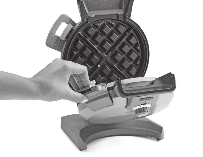 Open the waffle maker by pressing the stay-cool latch on the side of the unit, and use the latch to carefully lower the front plate. BE CAREFUL not to touch the hot plate.