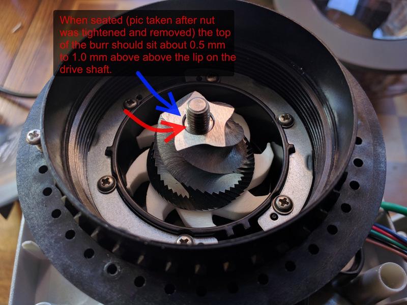 If it's too tight to go on, you can file it very slightly to make it fit. Install the lower burr on top of the impeller.