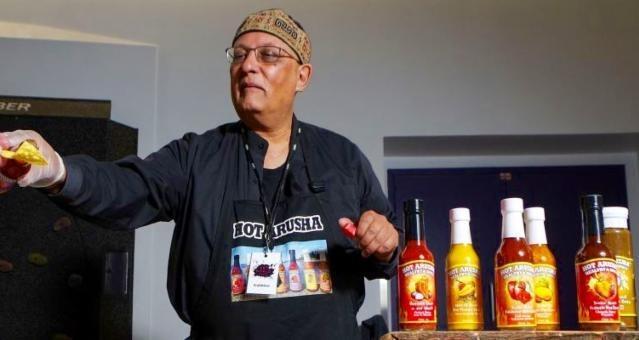 Iqbal is always happy to offer samples of his Hot Arusha sauces which trace their roots