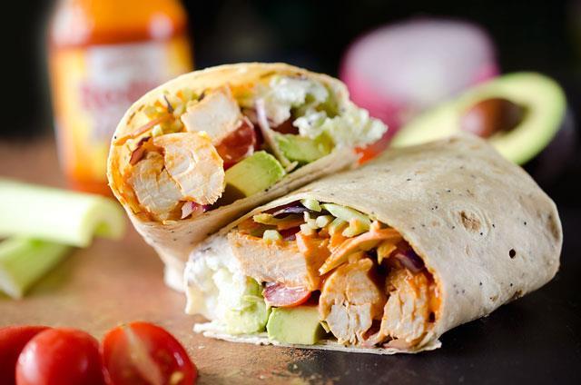12 Buffalo Chicken Wraps 1 tablespoon vegetable oil 1 tablespoon butter 1 pound skinless, boneless chicken breasts, cut into bite-size pieces 1/4 cup hot sauce 10 inch flour tortillas 2 cups shredded