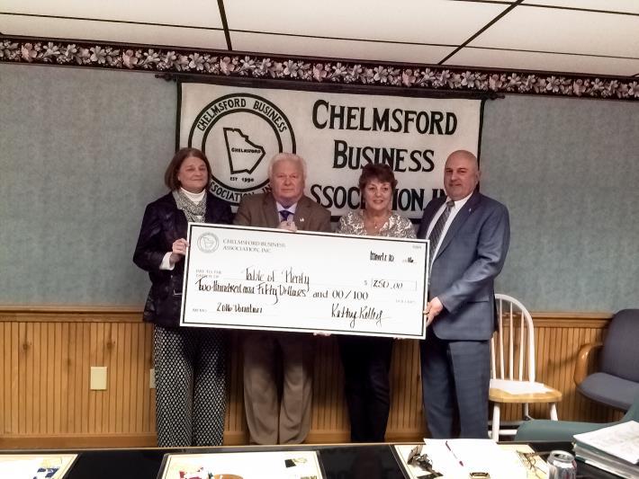 Seen here presenting the check are Kathy Kelley, President of the CBA; John Harrington, Executive Director of the CBA; Kathy Clark of Table of Plenty; and Tom Boucher, Vice