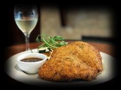 From the Farm: Chicken Schnitzel: Crumbed chicken breast topped with your choice of sauce (Sauces: Parmigiana, Gravy, Mushroom, Creamy Garlic, Garlic Butter, Pepper), served with chips and salad -
