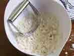 Start by adding about half, mix it into dough, and then add more water as