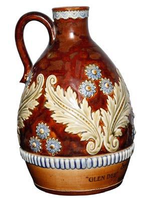 25 H $675 An intricate leaf and floral pattern adorns this Royal Doulton stoneware bottle for the whisky dealer whose name is