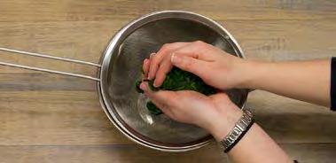 Once cool enough to handle, use your hands to squeeze liquid from spinach.