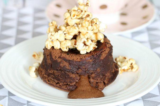 CHOCOLATE MOLTEN LAVA CAKES 200g good quality dark chocolate, chopped 200g butter, chopped 200g caster sugar 4 eggs + 4 additional yolks 200g plain flour, sifted Extra butter for greasing Cocoa