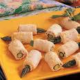 OVEN CRISP ASPARAGUS ROLLS 16 asparagus spears 230g butter, softened 2 tblspn coarse grain mustard Grated rind of 1 lemon 16 slices of bread with crusts removed Salt and black pepper Trim the