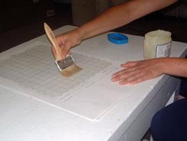 A commercial sticky board placed under a screened bottom