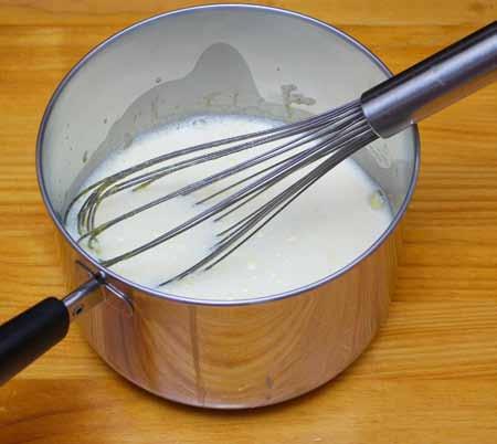 17 11 Whisking constantly, pour about a third of the hot milk into the egg mixture and combine well. This is called tempering the eggs and helps prevent them from cooking into a scrambled egg mess.