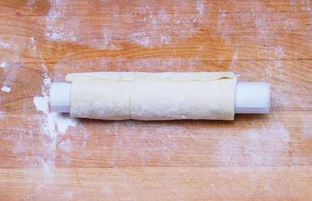 pastry. Wrap a square of pastry dough around a tube and brush the end with egg white.