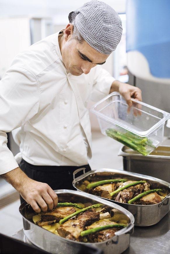 The chef puts the finishing touches to his dish of the day: leg of lamb served with asparagus and gratin dauphinois.