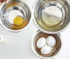 2 When you have made the dent, use two thumbs in the dent and open the egg carefully, allowing the unbroken yolk to settle into one side of the shell as the white pours off into the bowl.