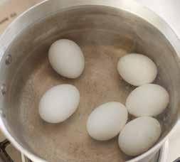 3 Carefully lower the eggs into the water. See Figure 3.11a. 4 Cook for 3 to 8 minutes for soft-boiled eggs; cook 10 minutes for hard-boiled eggs. See Figure 3.11b.