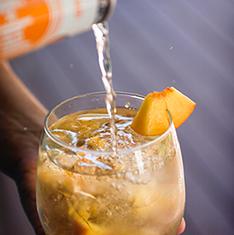 Strain into a highball glass filled with ice and top with Hiball Peach Sparkling Energy Water. Garnish with fresh peach. Peach Spritzer 5.0 oz.